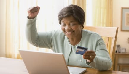 Senior African woman shopping online