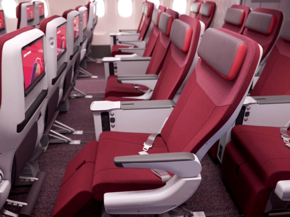 The red premium economy seat reclined.