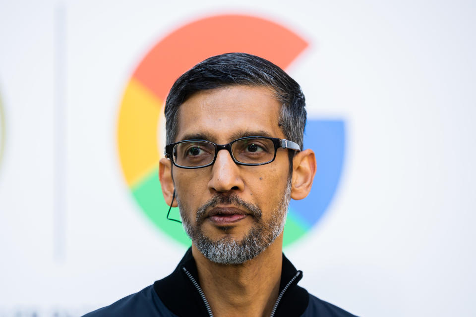 Sundar Pichai, CEO of Google and Alphabet, is pictured in front of the Google logo.