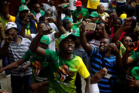 Supporters of President Emmerson Mnangagwa's ruling ZANU-PF party react to the results of a constitutional court hearing challenging his electoral victory in Harare, Zimbabwe August 24, 2018. REUTERS/Philimon Bulawayo