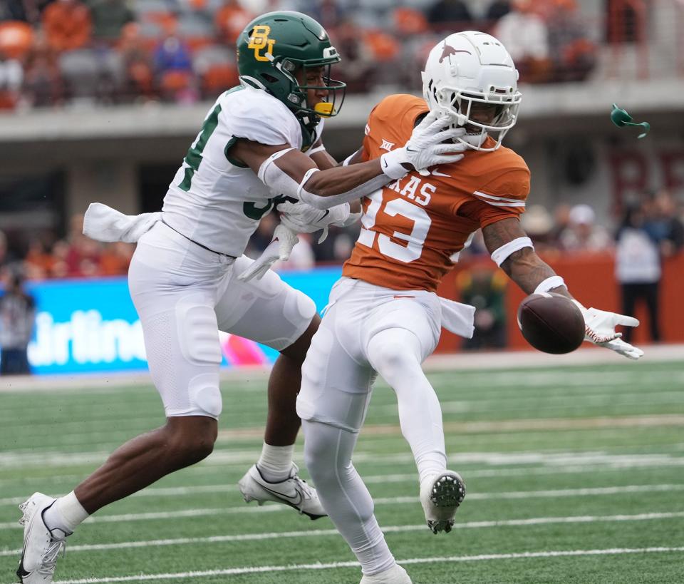 Texas defensive back Jahdae Barron attempts to intercept a pass intended for Baylor's Josh Cameron in last year's game. Barron, a Connally graduate, will again match up with Cedar Park product Cameron on Saturday in Waco, where Texas will begin its final Big 12 run.