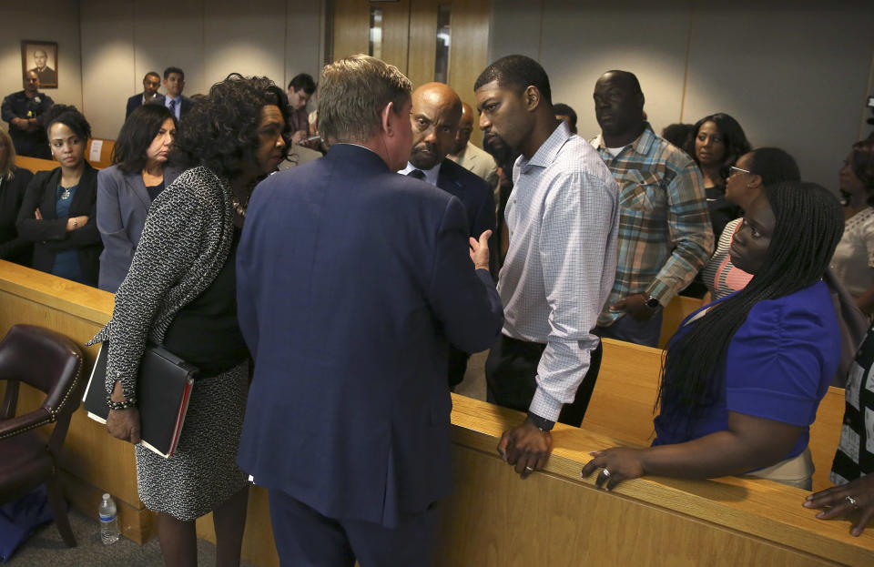 Lead prosecutor Michael Snipes, second from left, and Dallas County District Attorney Faith Johnson, left, talk to Odell and Charmaine Edwards after former Balch Springs Police Officer Roy Oliver was sentenced to 15 years in prison for the murder of their son Jordan Edwards, 15, Wednesday, Aug. 29, 2018, at the Frank Crowley Courts Building, in Dallas. (Rose Baca/The Dallas Morning News via AP, Pool)