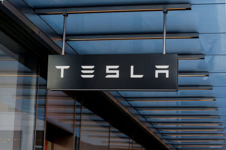 FILE PHOTO: A sign is seen outside Tesla Motors' new showroom in Manhattan's Meatpacking District in New York City, U.S., December 14, 2017. REUTERS/Brendan McDermid/File Photo