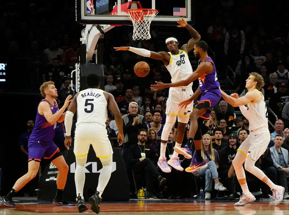 November 26, 2022; Phoenix, Ariz; USA; Suns wing Mikal Bridges (25) passes to center Jock Landale (11) against the defense of Jazz forward Jarred Vanderbilt (during a game at the Footprint Center. 