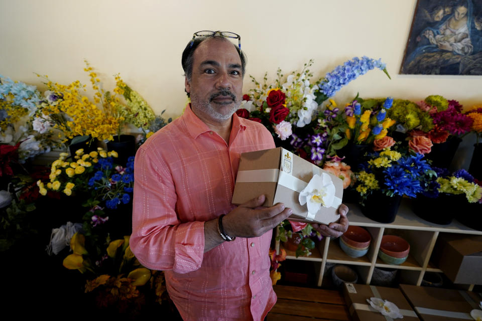 Martin Garcia, owner of gift and décor store Gramercy Gift Gallery, poses for a photo at his shop, Wednesday, June 29, 2022, in San Antonio. Landlords were forgiving about rent during the first two years of the pandemic, but now many are asking for back due rent. Meanwhile, most of the government aid programs that helped small businesses get through the pandemic have ended. (AP Photo/Eric Gay)