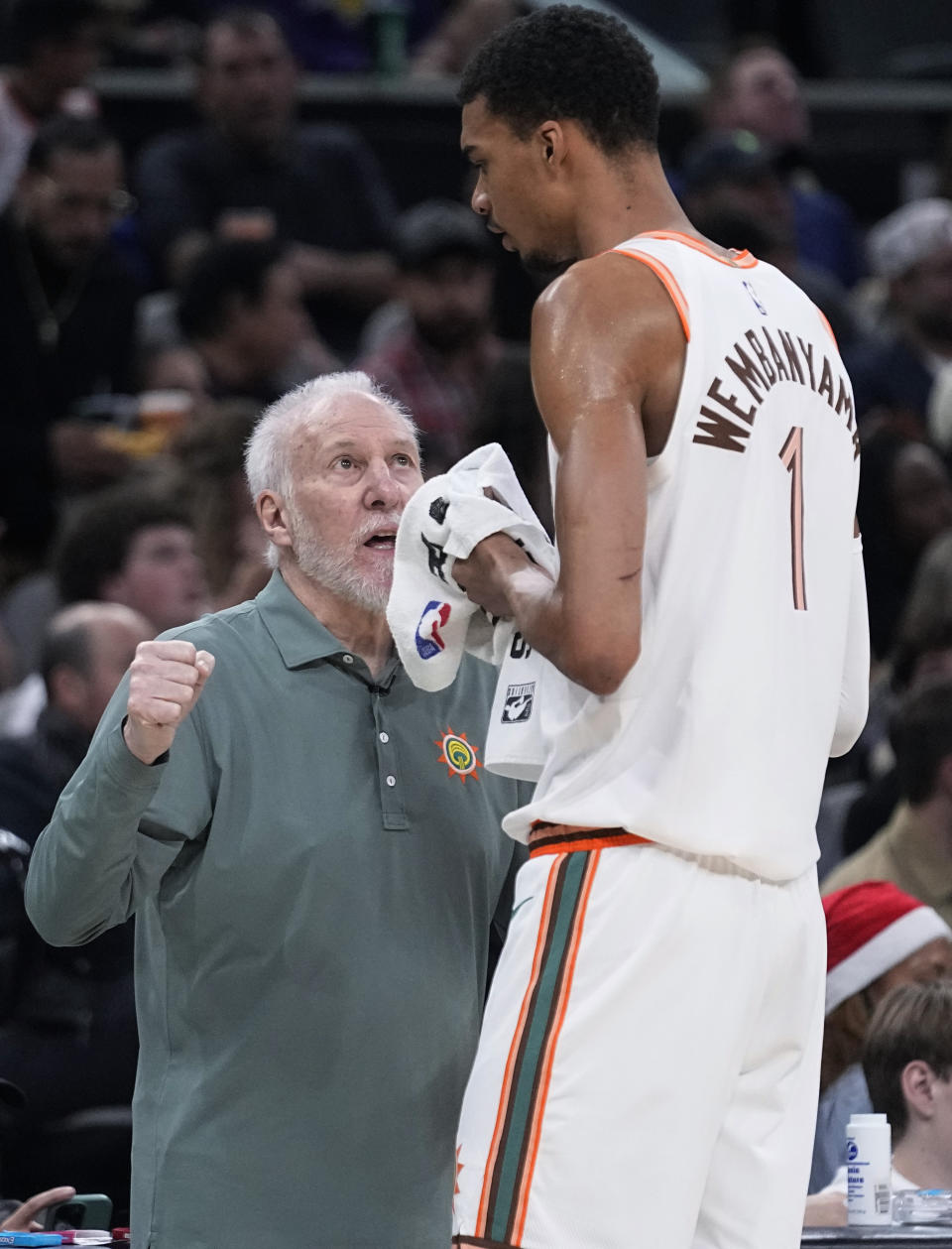 San Antonio Spurs coach Gregg Popovich, left, talks with center Victor Wembanyama during the first half of the team's NBA basketball game against the Los Angeles Lakers in San Antonio, Friday, Dec. 15, 2023. (AP Photo/Eric Gay)