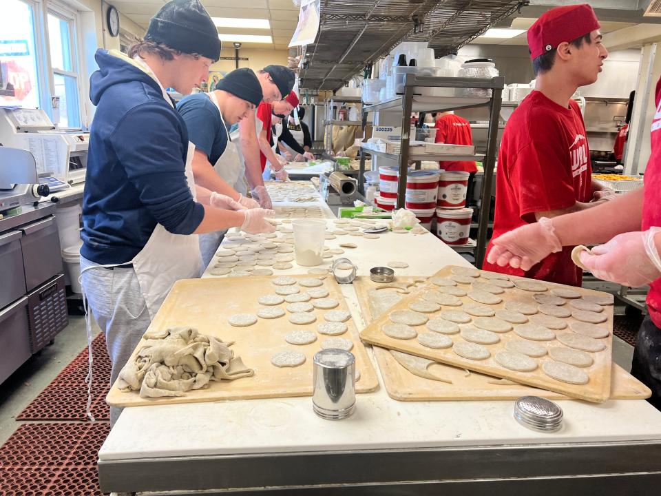 High school football players from Pinelands Regional, Wall Township and Point Pleasant Borough help Joe Leone make pierogi, with all proceeds going to help the people of Ukraine.