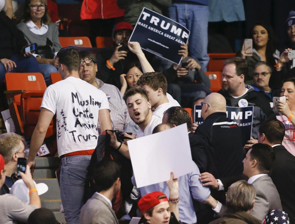 Protesters are escorted out of UIC Pavilion before Republican U.S. presidential candidate Donald Trump's rally at the University of Illinois at Chicago March 11, 2016. REUTERS/Kamil Krzaczynski