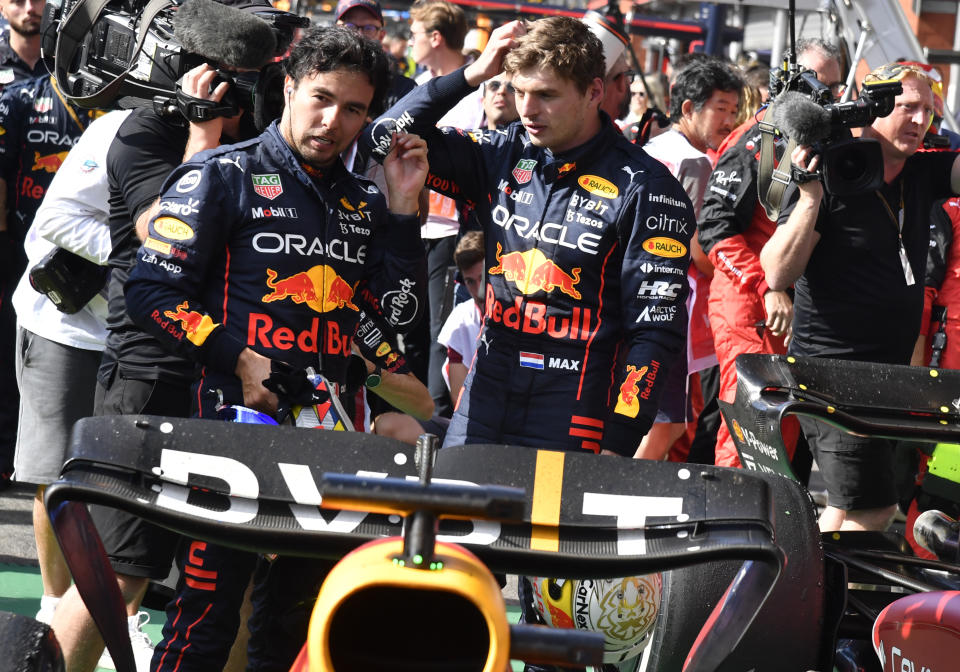 First place, Red Bull driver Max Verstappen of the Netherlands, right, speaks with second place Red Bull driver Sergio Perez of Mexico sin the Parc Ferme after the Formula One Grand Prix at the Spa-Francorchamps racetrack in Spa, Belgium, Sunday, Aug. 28, 2022. (AP Photo/Geert Vanden Wijngaert, Pool)