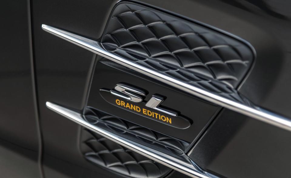 <p>Outside, Mercedes adds yellow Grand Edition type to the double-lined fender embellishments and borrows some of the AMG SL63's matte silver trim for the chin spoiler, although SL historians will note the Grand's chrome rocker panels and outside air intakes are unique to this model.</p>