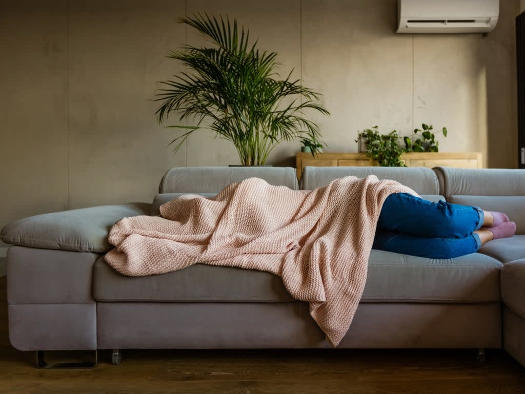 A person with a hangover covered by a blanket (Getty Images)