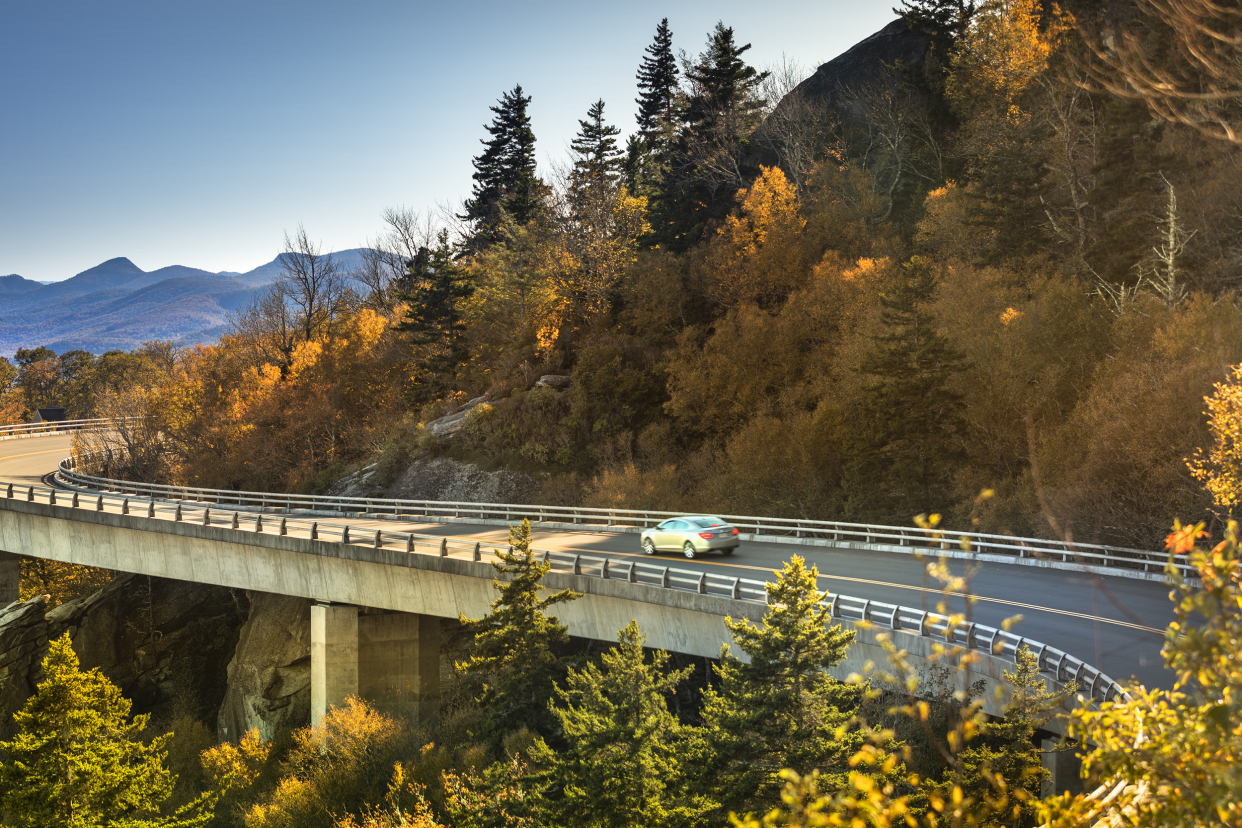 Car on a winding road in autumn