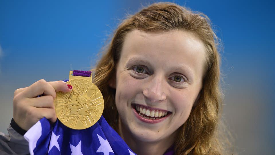 Katie Ledecky poses on the podium after winning gold in the women's 800m freestyle final at the London 2012 Olympics. - Fabrice Coffrini/AFP/Getty Images