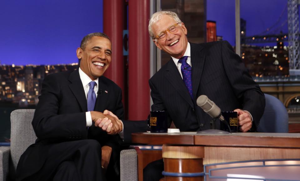 Seated with talk show host David Letterman, U.S. President Barack Obama makes an appearance on the "Late Show with David Letterman" at the Ed Sullivan Theater in New York City in this September 18, 2012, file photo. Letterman, longtime host of television's "The Late Show" on CBS, will retire from the network in about a year and discussed his plans to leave during the taping of his show on Thursday, a source with knowledge of the program said, April 3, 2014. REUTERS/Kevin Lamarque/Files (UNITED STATES - Tags: ENTERTAINMENT)