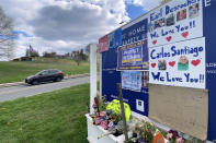 Tributes to veterans cover a sign Tuesday, April 28, 2020, near an entrance road to Soldiers' Home in Holyoke, Mass., where a number of people died due to the coronavirus. While the death toll at the state-run Soldiers' Home in Holyoke continues to climb, federal officials are investigating whether residents were denied proper medical care while the state's top prosecutor is deciding whether to bring legal action. (AP Photo/Rodrique Ngowi)