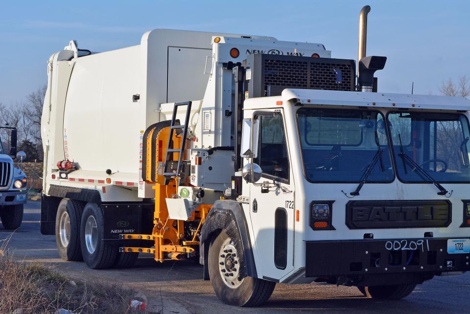 One of the city's new automated trash collection trucks sits ready to depart Monday from the city landfill on Peabody Road. Following delivery of trash roll carts last month, the city's new trash collection system is active.