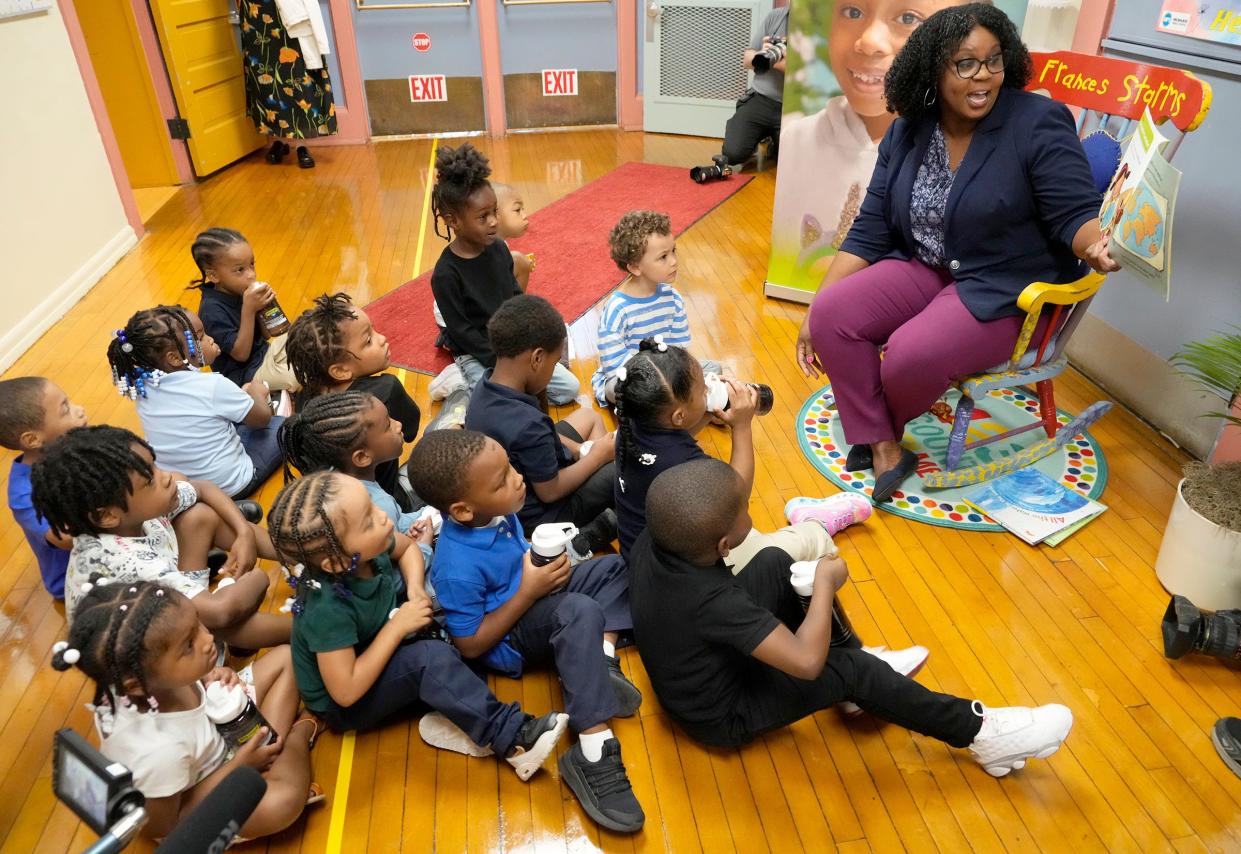 Christy Stone, Milwaukee Public Schools director of strategic partnership, reads a story about water to K4 and K5 students who had just filled their water bottles at the new filtered drinking fountain at Frances Brock Starms Early Childhood Center on West Garfield Avenue in Milwaukee on Monday.  Milwaukee Public Schools has installed nearly 600 new Elkay filtered bottle filling stations and converted 2,500 existing filtered drinking fountains.