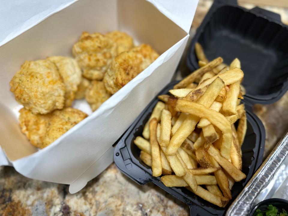 Fries and Cheddar bay biscuits from red lobster in takeout containers