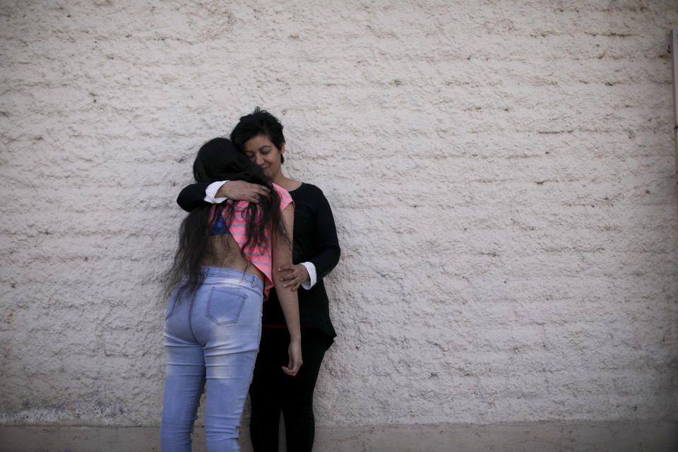 In this Aug. 1, 2019 photo, Paola Gonzalez hugs her daughter, one of about 20 ex-students from the Antonio Próvalo School for Deaf and Hearing Impaired Children in Mendoza province who say they were sexually abused by two Roman Catholic priests, including cases of rape, in Mendoza, Argentina. "Two and a half years have passed (since the Mendoza case was uncovered) and Francis has not uttered a single word to the survivors of the Próvolo in Mendoza," said González, referring to the Argentine pope. (AP Photo/Natacha Pisarenko)