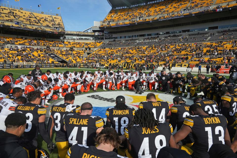 The Cleveland Browns and Pittsburgh Steelers kneel in prayer for injured Buffalo Bills safety Damar Hamlin before an NFL football game in Pittsburgh, Sunday, Jan. 8, 2023. (AP Photo/Matt Freed)