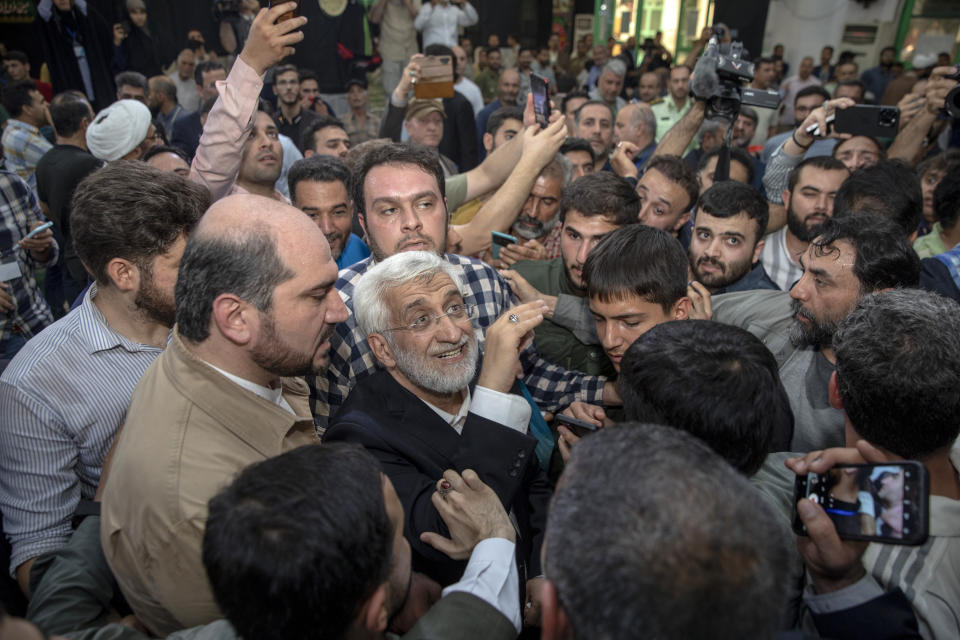 Candidate for the Iran's presidential election Saeed Jalili, a hard-line former nuclear negotiator, is greeted by his supporters after casting his vote for the presidential runoff election in Qarchak near Tehran, Iran, Friday, July 5, 2024. Iran was holding a runoff presidential election Friday pitting a hard-line former nuclear negotiator against a reformist lawmaker, though both men earlier struggled to convince a skeptical public to cast ballots in the first round that saw the lowest turnout in the Islamic Republic's history. (AP Photo)