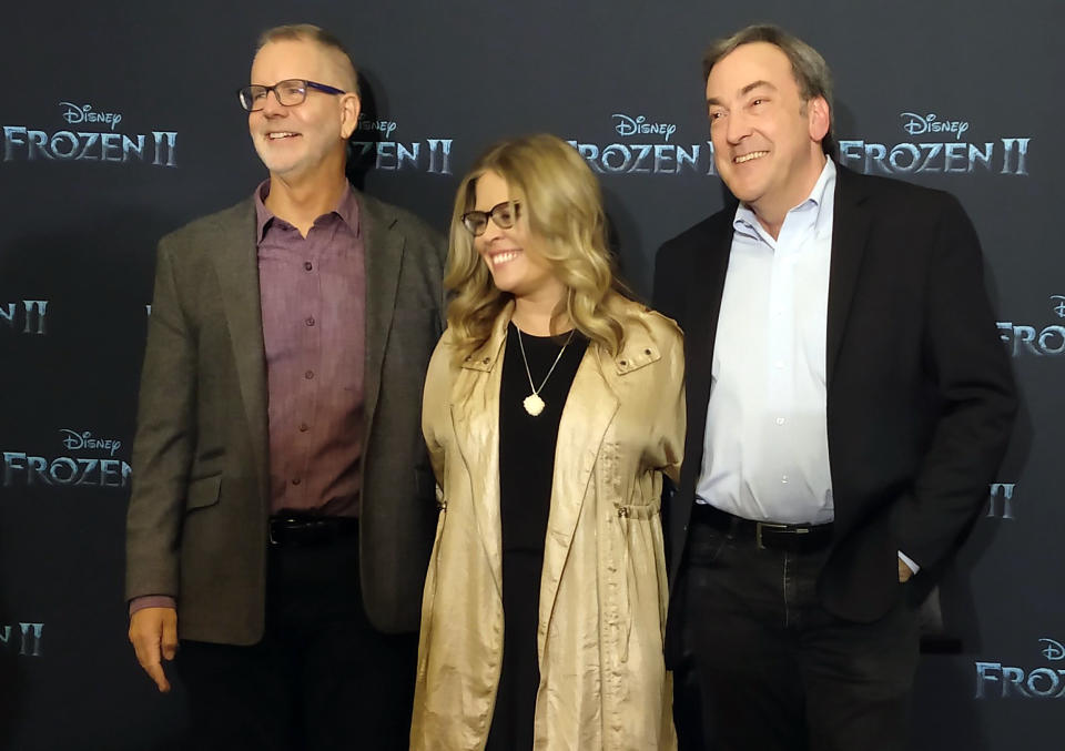 Director Chris Buck, left, director Jennifer Lee, center, and producer Peter Del Vecho, pose fot photos during a press conference to promote the film Frozen II, in Mexico City, Monday, Nov. 4, 2019. (AP Photo/Berenice Bautista)