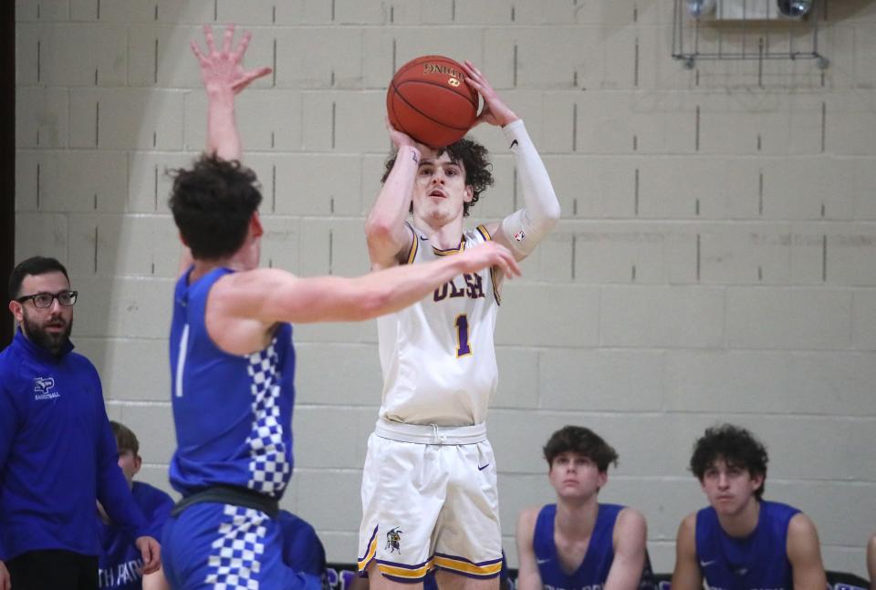 OLSH's Rocco Spadafora (1) attempts a three point shot after gaining distance from South Park's Tyler Susan (1) during the first half Friday night at Our Lady of the Sacred Heart High School.