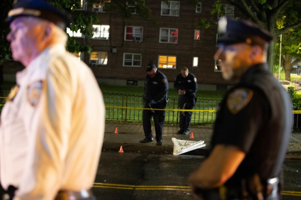 Police investigate the scene of the shooting on Wednesday evening. Robert Mecea