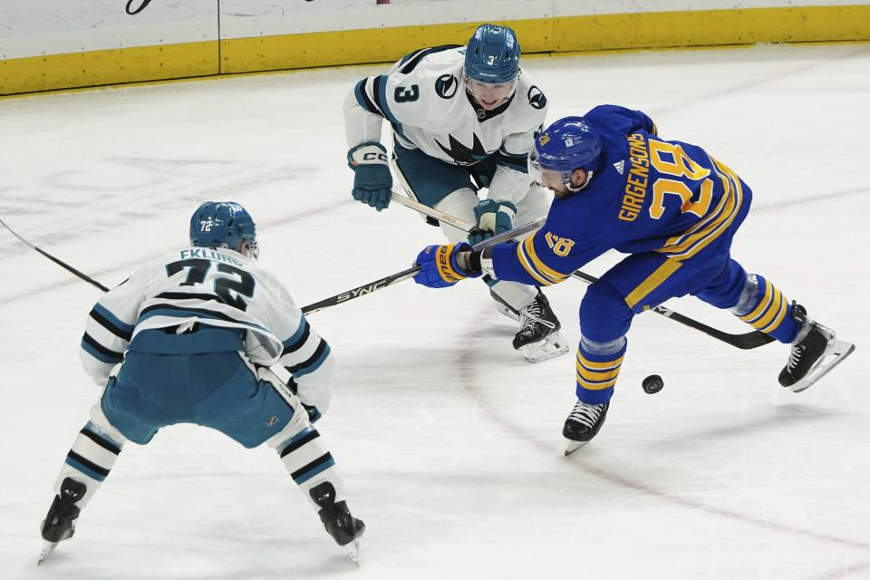 Buffalo Sabres' Zemgus Girgensons battles for the puck with San Jose Sharks' Henry Thun (3) and William Eklund (72) during an NHL hockey game at KeyBank Center in Buffalo, N.Y., Monday, Jan. 15, 2024. (Libby March//The Buffalo News via AP)