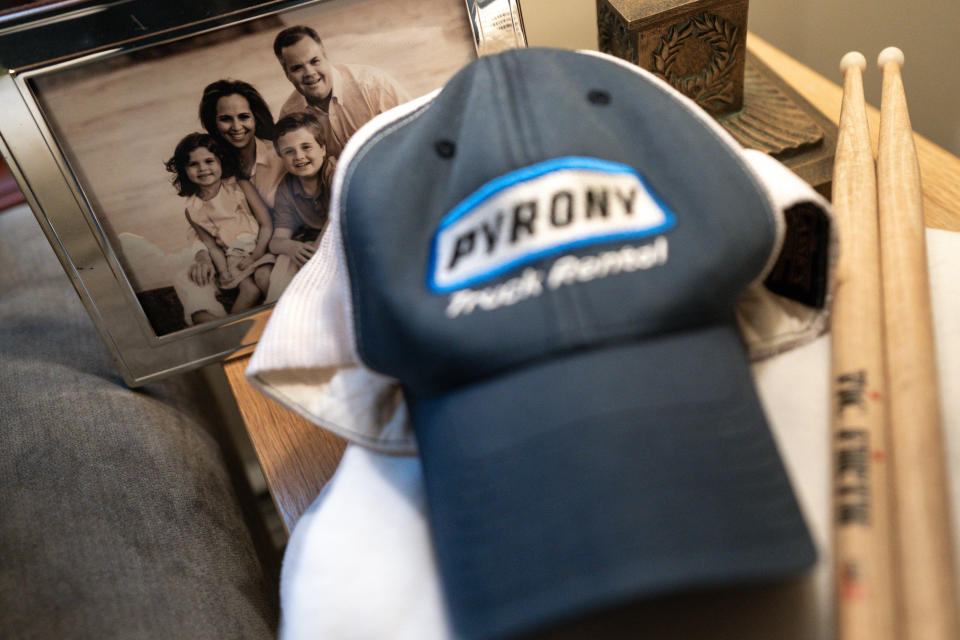 A family photo is displayed in Brenda and Brian Lilly's home, Thursday, Oct. 13, 2022, in Easton, Conn. Brian Lilly Jr., 19, who committed suicide on Jan. 4, 2021, was a rower at University of California San Diego. The Lillys have filed a wrongful death lawsuit against the university and the rowing coach, Geoff Bond, who is no longer with the school. (AP Photo/Julia Nikhinson)