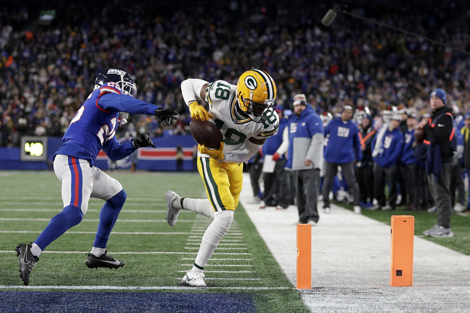 Green Bay Packers wide receiver Malik Heath (18) catches a pass against New York Giants cornerback Deonte Banks (25) for a touchdown during the fourth quarter of an NFL football game, Monday, Dec. 11, 2023, in East Rutherford, N.J. (AP Photo/Adam Hunger)