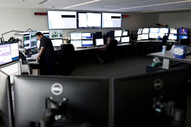 Satellite controller Sean Sauve and lead satellite controller Michael Arsenault work at the offices of Telesat in Ottawa