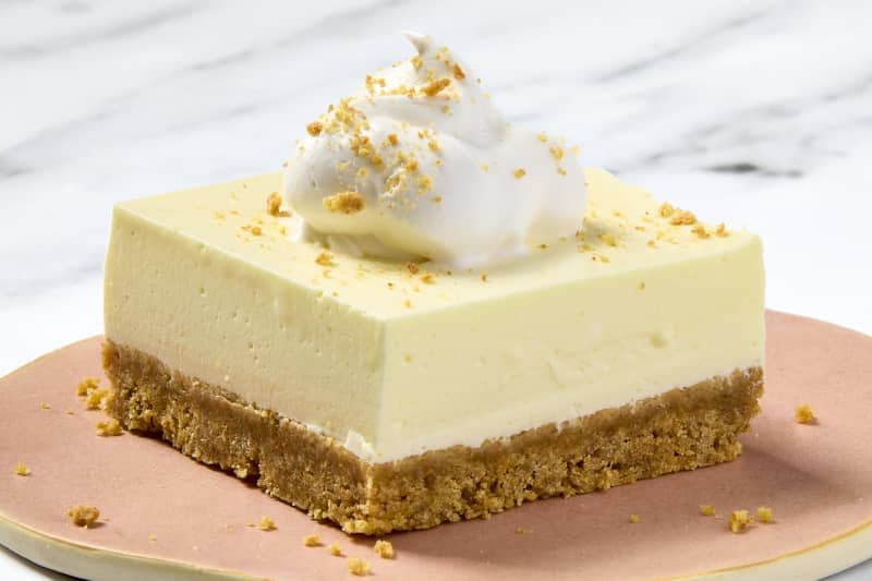 angled shot of a slice of lemon fluff on a small flat pink plate.