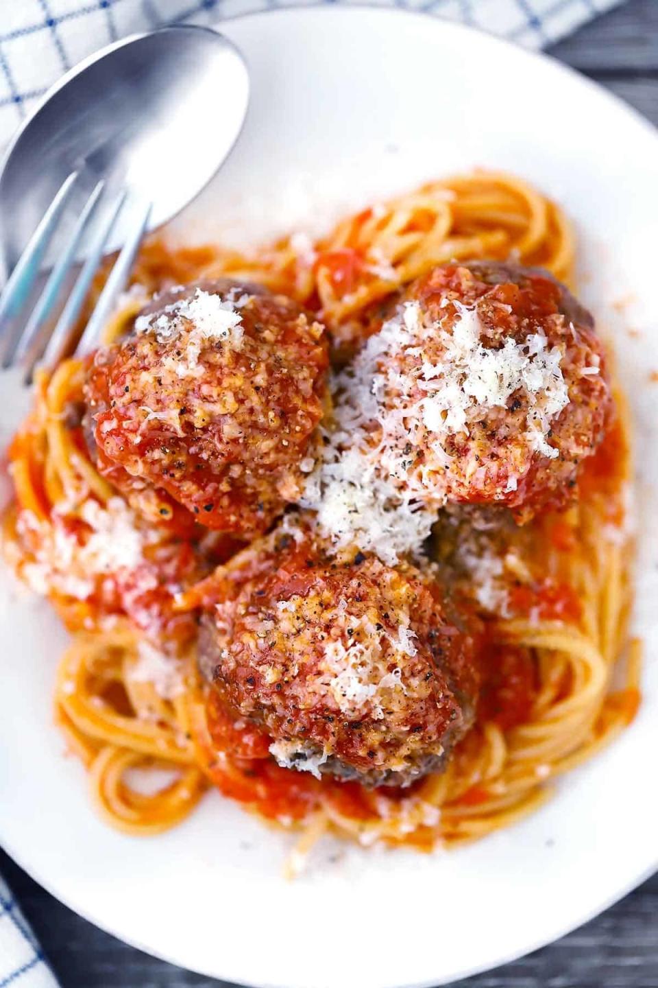 Beef meatballs over spaghetti.