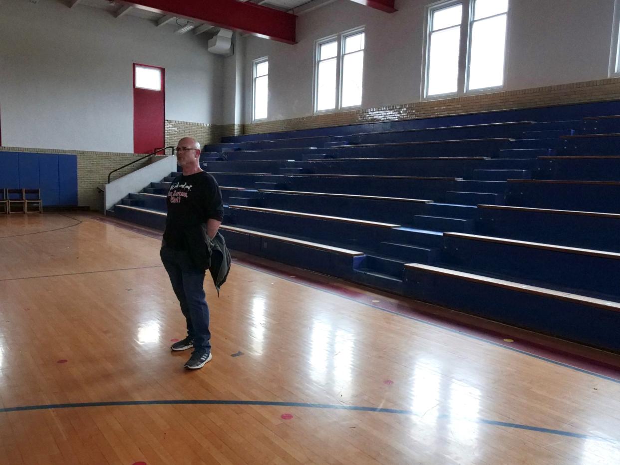 Scott Coffey, the former dean of students at Hebron Elementary School, stands in the building’s empty gymnasium in early December. The school was closed at the end of the 2022-2023 school year after opening in 1914.