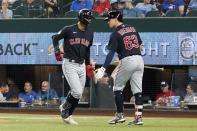 Cleveland Guardians' Andres Gimenez, left, and Will Brennan (63) celebrate after Gimenez hit a solo home run in the seventh inning of a baseball game against the Texas Rangers in Arlington, Texas, Saturday, Sept. 24, 2022. (AP Photo/Tony Gutierrez)