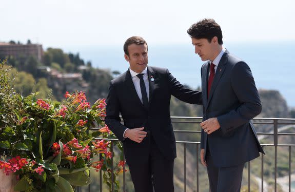 Canadian Prime Minister Justin Trudeau (R) and French President Emmanuel Macron talk during a bilateral meeting as they attend the Summit of the Heads of State and of Government of the G7, the group of most industrialized economies, plus the European Union, on May 26, 2017 in Taormina, Sicily. The leaders of Britain, Canada, France, Germany, Japan, the US and Italy will be joined by representatives of the European Union and the International Monetary Fund (IMF) as well as teams from Ethiopia, Kenya, Niger, Nigeria and Tunisia during the summit from May 26 to 27, 2017. / AFP PHOTO / POOL / STEPHANE DE SAKUTIN (Photo credit should read )