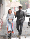 <p>Olivia Palermo and husband Johannes Huebl make their way through the rain during Milan Fashion Week on Friday in Italy.</p>