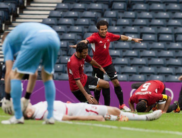 Egypt reach the Olympics football knock-out stage for the first time since 1964.