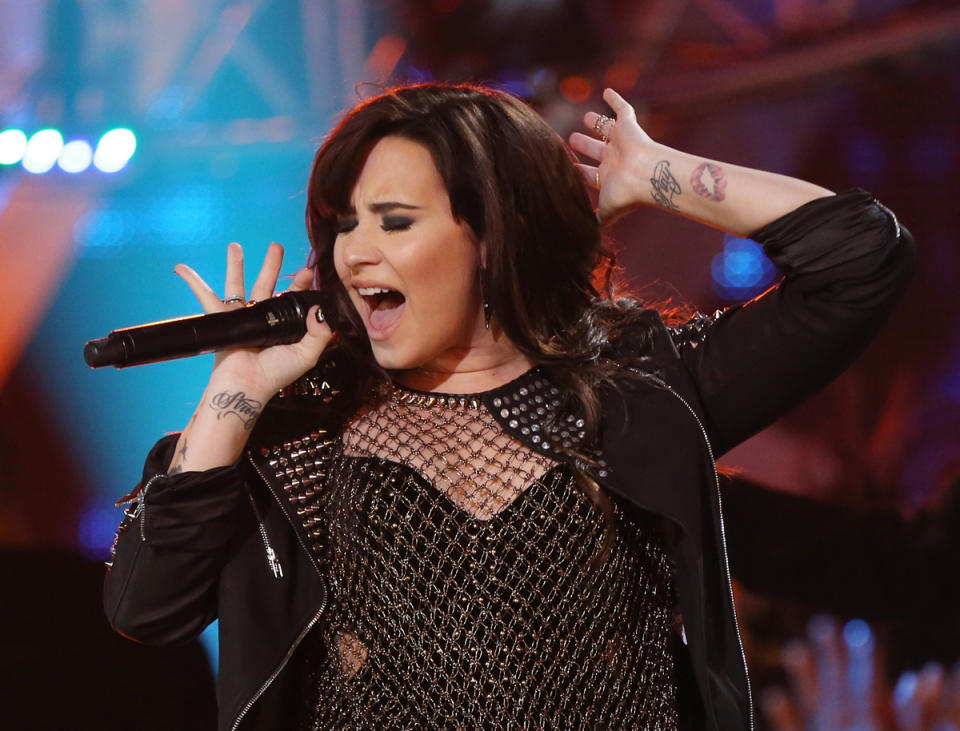 <p>Lovato has roughly 20 tattoos, one of which included an illustration of a vagina that she has since covered up with a flower. (Photo: Getty Images) </p>