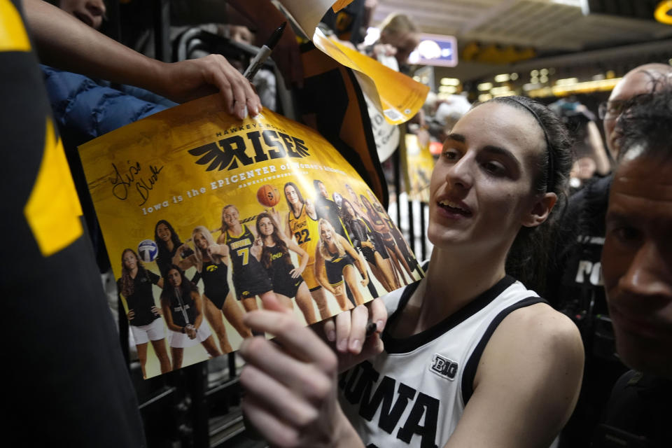 Iowa guard Caitlin Clark signs autographs after an NCAA college basketball game against Penn State, Thursday, Feb. 8, 2024, in Iowa City, Iowa. Iowa won 111-93. (AP Photo/Charlie Neibergall)