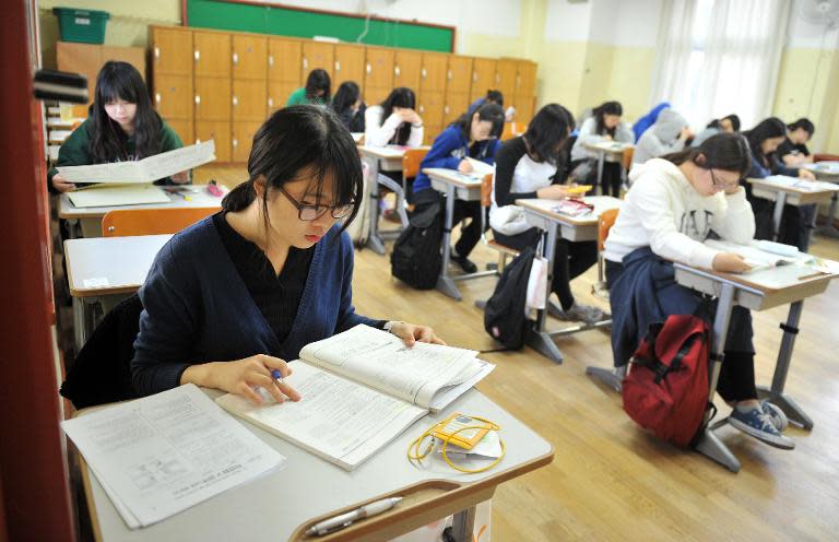 South Korean students prepare to take the College Scholastic Ability Test, a standardised exam for college entrance, at a high school in Seoul, on November 7, 2013