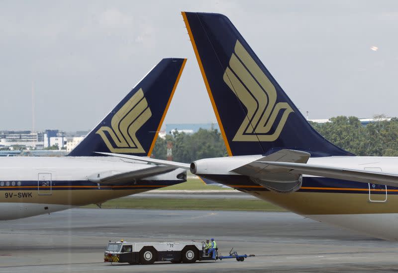 FILE PHOTO: Singapore Airlines (SIA) planes sit on the tarmac in Singapore's Changi Airport