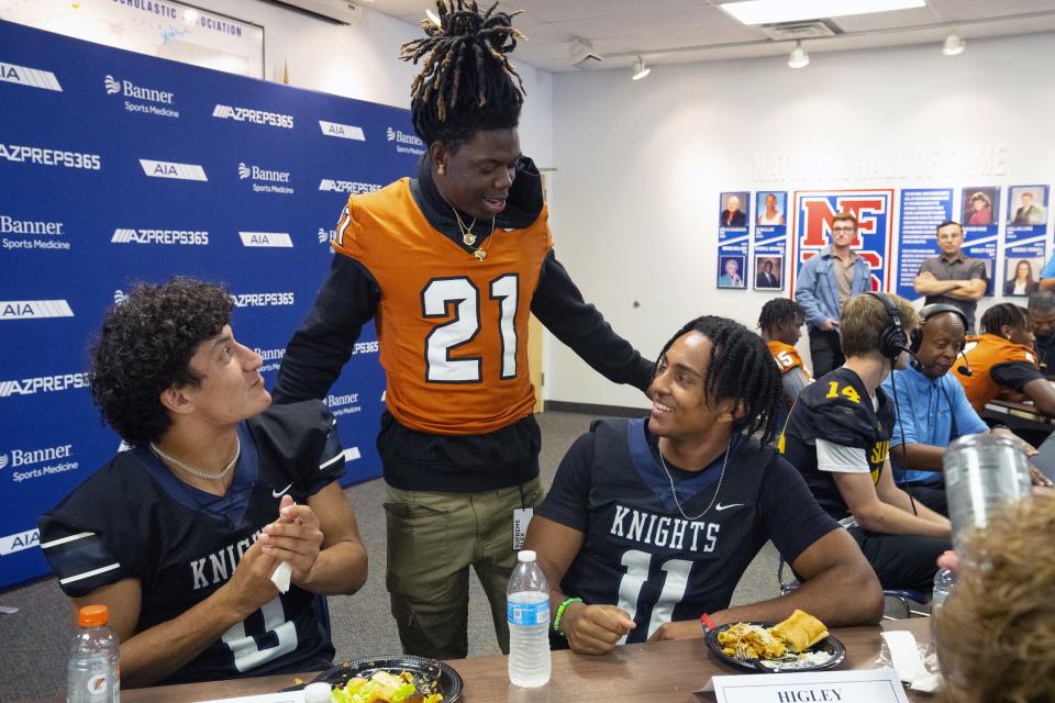 Higley's Andrew Zubey (left) speaks with Desert Edge's Audre Gibson and Higley's Donovan Aidoo during the Arizona Interscholastic Association high school state football championship media day in Phoenix on Nov. 29, 2023.