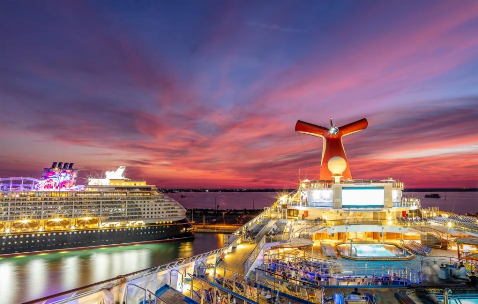 Carnival Liberty and Disney Dream cruise ships docked in Port Canaveral at sunset via Getty Images