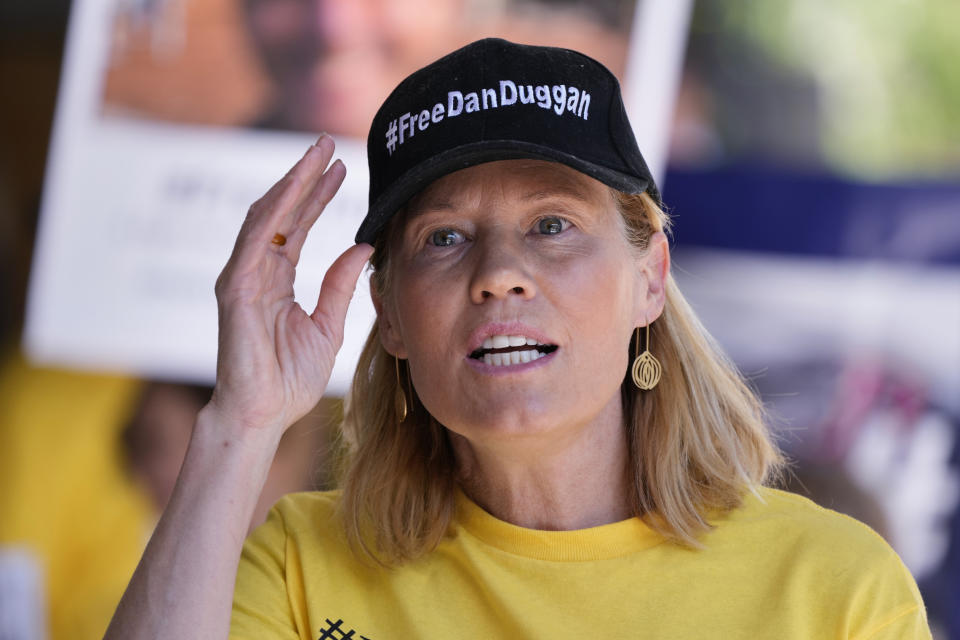 Saffron Duggan speaks outside Downing Central Court in Sydney, Monday, Oct. 23, 2023, as family and supporters of Dan Duggan demonstrate. A Sydney court on Monday postponed an extradition hearing for Dan Duggan, a former U.S. military pilot accused of illegally training Chinese aviators, until May as his lawyers attempt to further build their case. (AP Photo/Rick Rycroft)