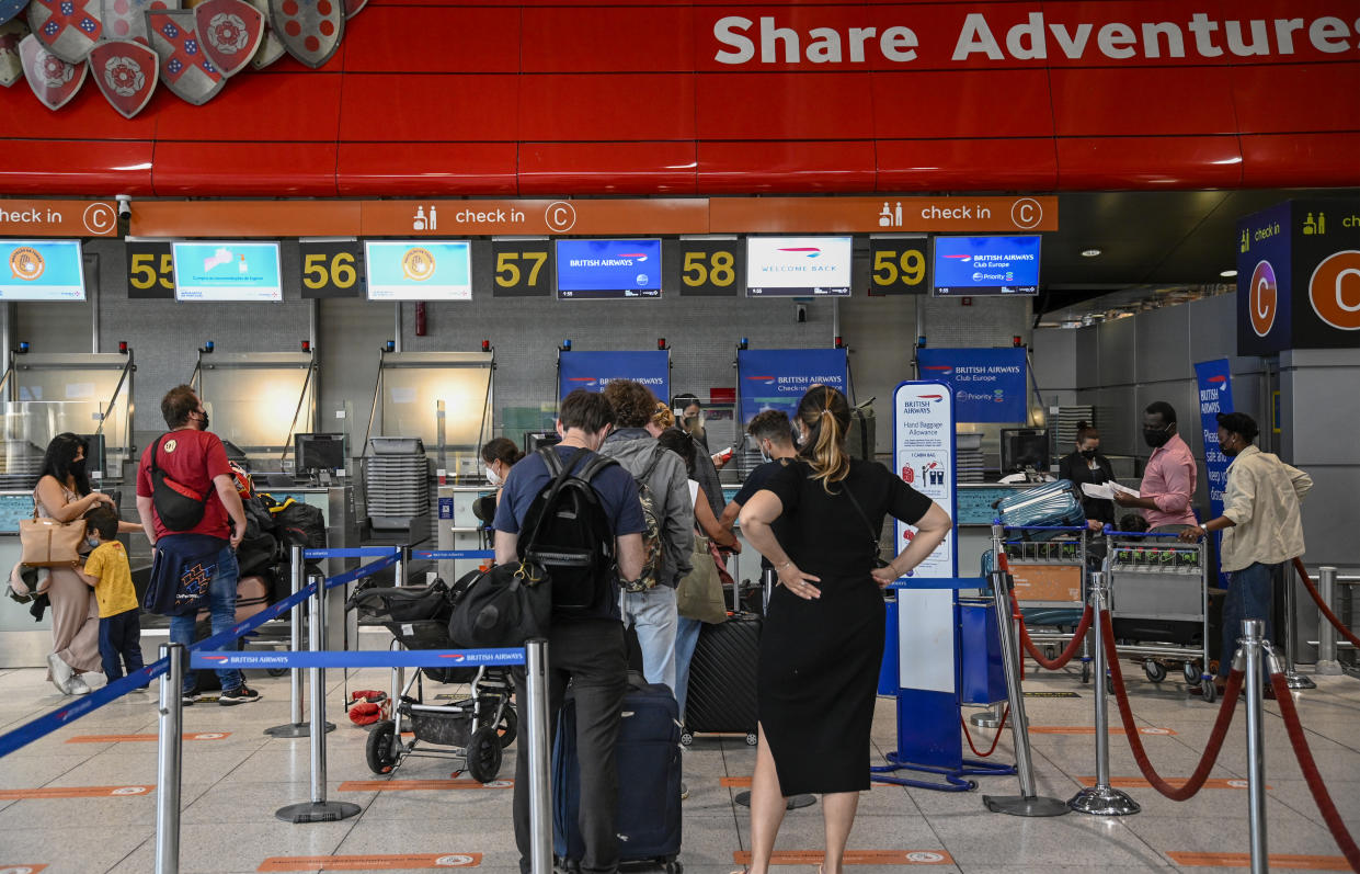 LISBON, PORTUGAL - JUNE 07: Mask-clad travelers queue at British Airways desks in Terminal 1 of Humberto Delgado International Airport a day before the country is taken off the UK's green list, imposing a mandatory ten-day quarantine to British residents returning home, during the COVID-19 Coronavirus pandemic on June 07, 2021 in Lisbon, Portugal. After the announcement of the British decision last June 03, thousands of British tourists interrupted their vacations and headed home. According to the president of the Algarve Tourist Board on June 05 alone, around 10,000 British tourists have departed Faro, in Algarve. (Photo by Horacio Villalobos#Corbis/Corbis via Getty Images)