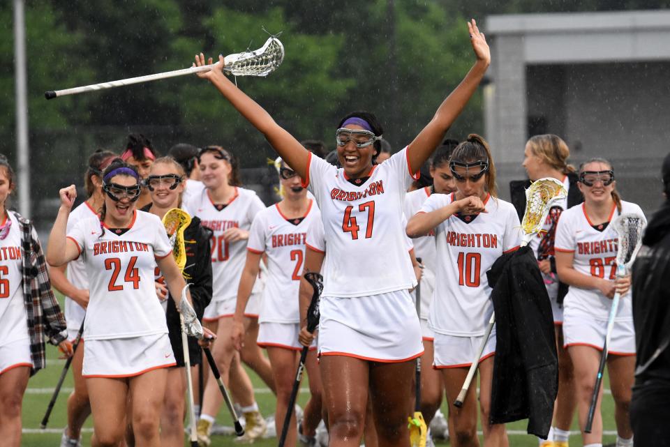 Amaria Whitby (47) leads Brighton's celebration following a 14-7 victory over Bloomfield Hills in a Division 1 state semifinal lacrosse game on Wednesday, June 8, 2022 at Brighton.