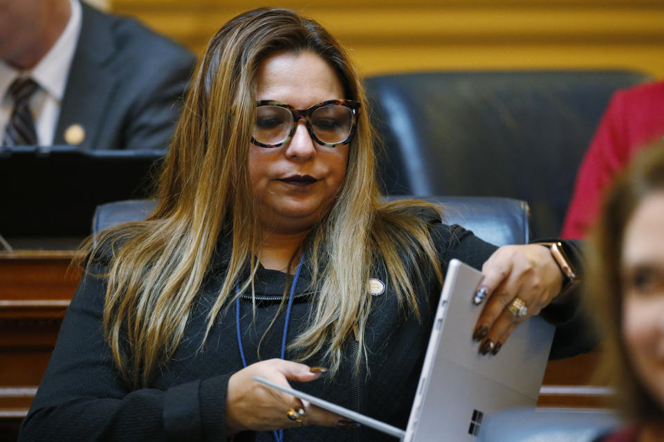 Del. Elizabeth Guzman, D-Prince William, opens her laptop during the House session at the Capitol Tuesday, Feb. 25, 2020, in Richmond, Va. Democratic lawmakers in Virginia appear poised to pass legislation extending collective bargaining rights to at least some public workers, a historic change backed by labor unions and opposed by business associations and many of the state's local governments. (AP Photo/Steve Helber)