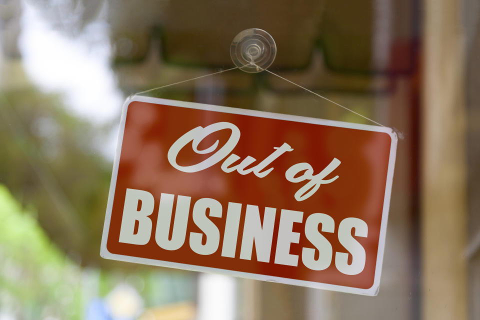 Sign on glass door reads "Out of Business"